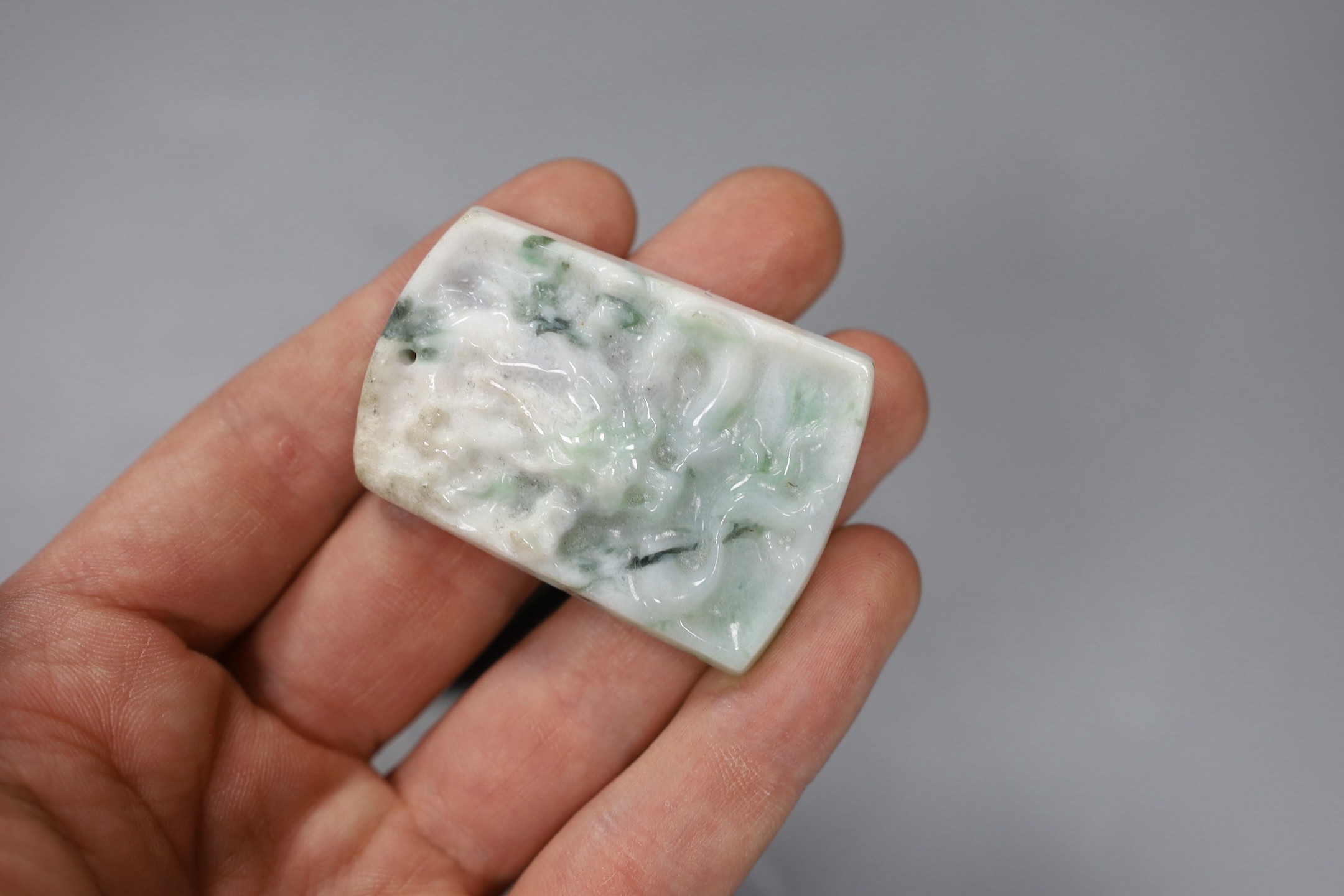 Four Chinese carved hardstone plaques, largest 5.7cm